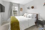 Third bedroom features a full-sized bed w/ dimmable, LED table lamps -second floor-